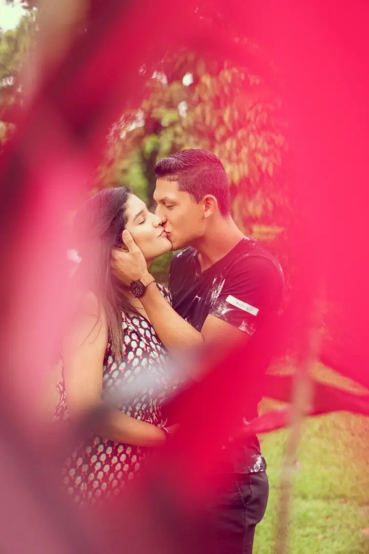 Pareja entre flores rojas